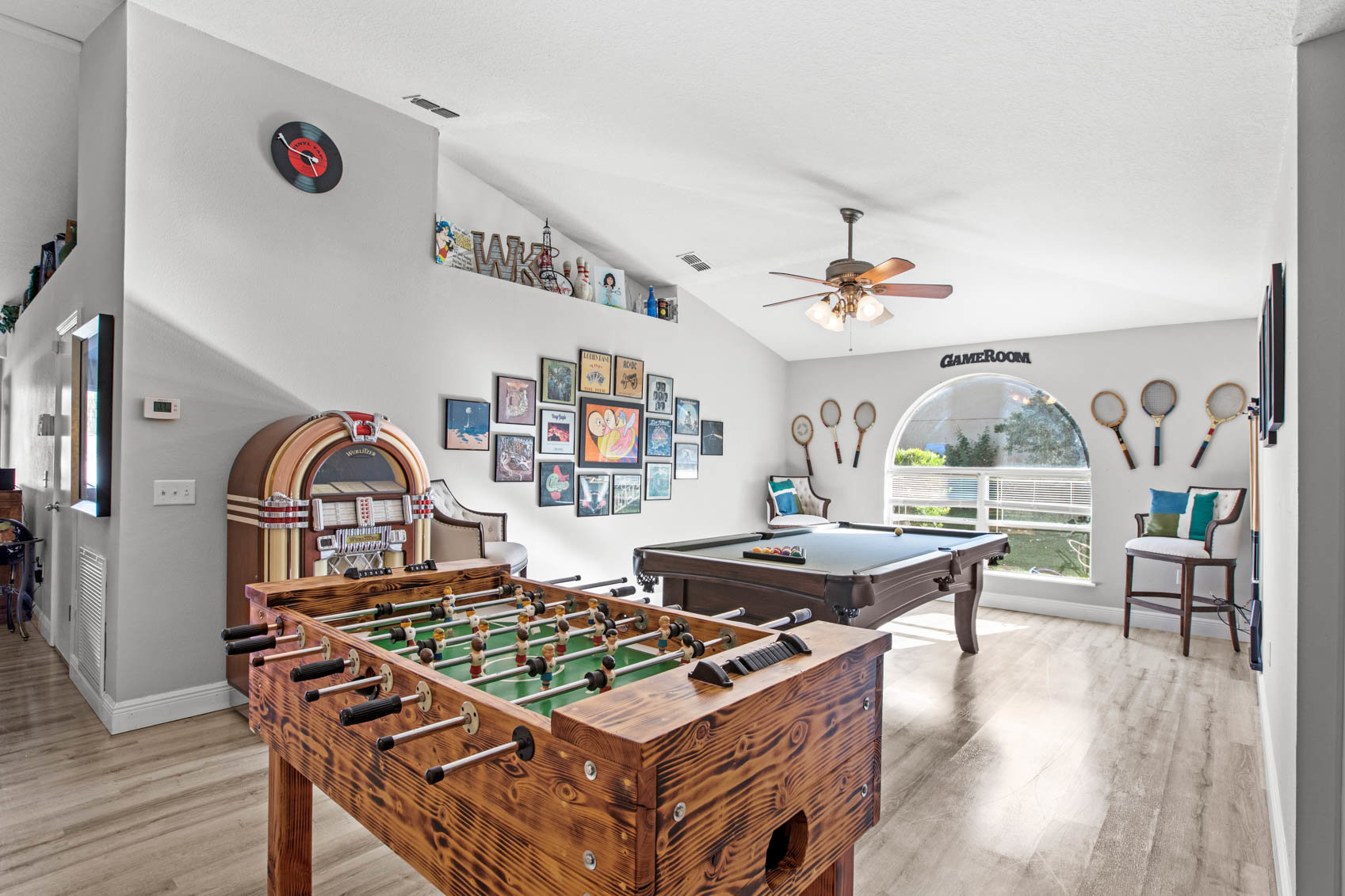 big room with window with billiards and air hockey table